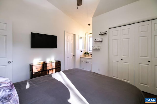 unfurnished bedroom featuring vaulted ceiling, ensuite bath, and a closet