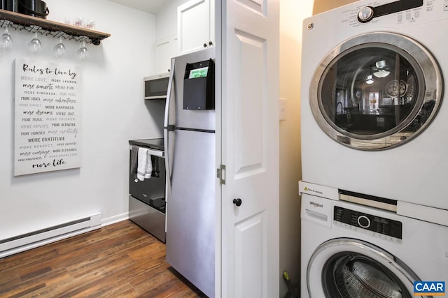 washroom featuring baseboard heating, stacked washing maching and dryer, and dark wood-type flooring