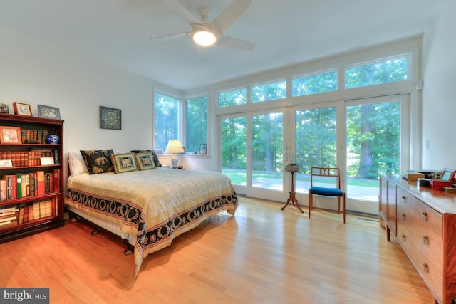 bedroom with access to exterior and light hardwood / wood-style flooring