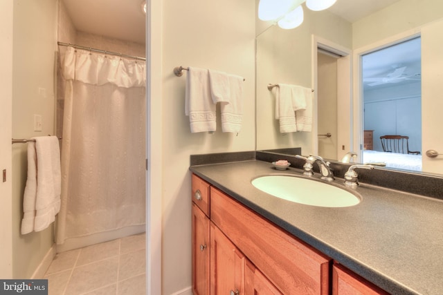 bathroom with walk in shower, tile patterned floors, and vanity