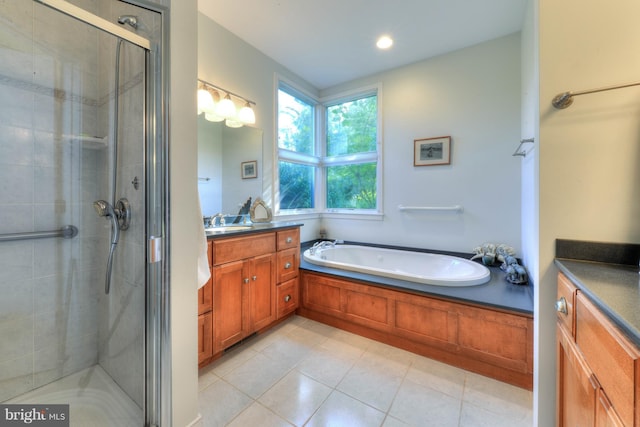 bathroom featuring tile patterned flooring, vanity, and separate shower and tub