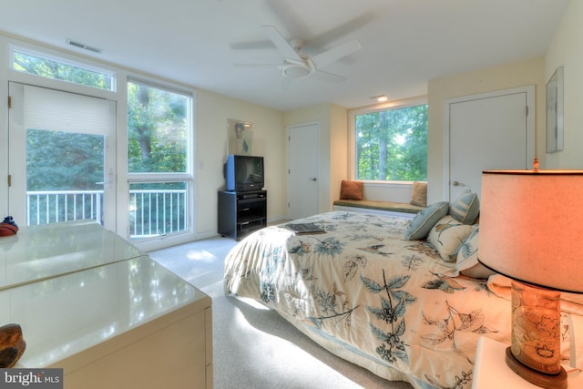 carpeted bedroom featuring access to outside and ceiling fan