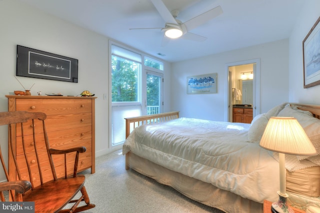 bedroom with connected bathroom, ceiling fan, and carpet