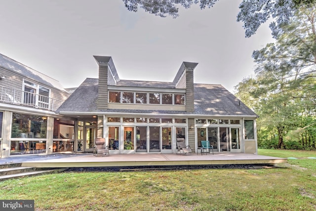 rear view of house with a yard