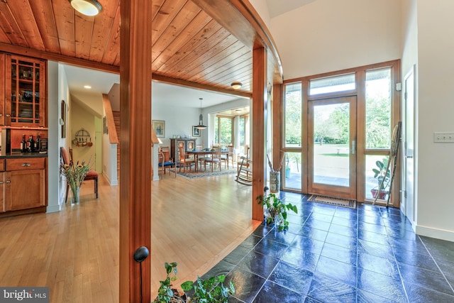 entryway featuring wood ceiling and dark hardwood / wood-style floors