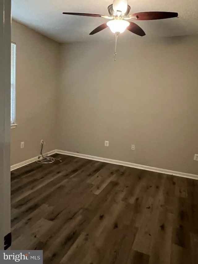 spare room featuring ceiling fan and dark hardwood / wood-style flooring