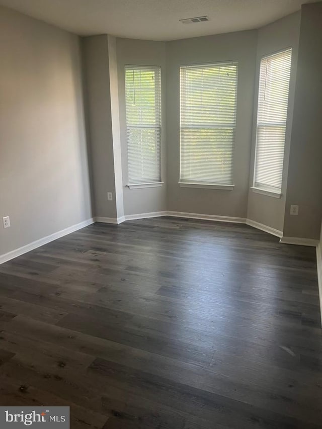 empty room featuring dark wood-type flooring