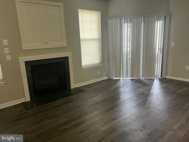 unfurnished living room featuring dark hardwood / wood-style flooring