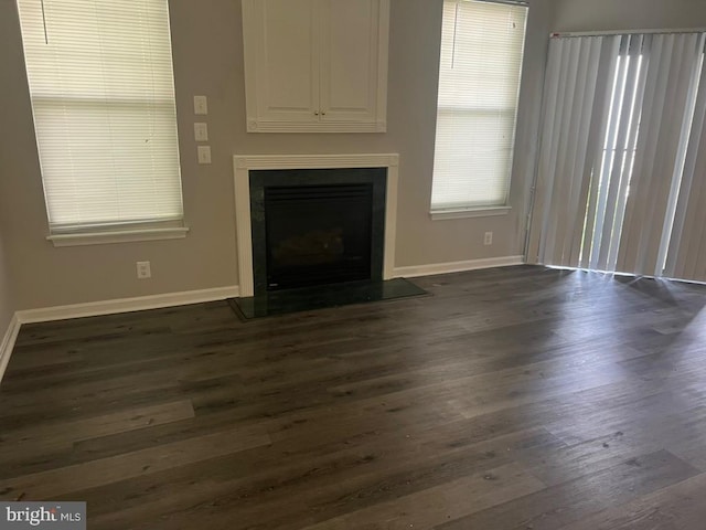 unfurnished living room featuring dark wood-type flooring