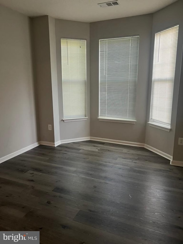 unfurnished room featuring dark hardwood / wood-style flooring