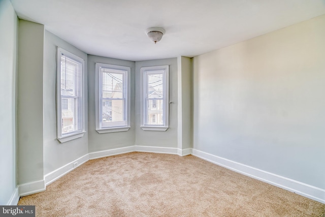 unfurnished room with light colored carpet