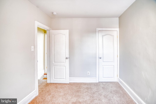 unfurnished bedroom featuring light colored carpet