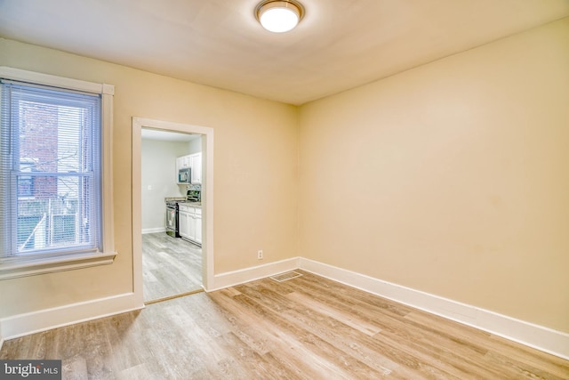 unfurnished room featuring light hardwood / wood-style floors