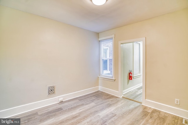 empty room with light hardwood / wood-style flooring