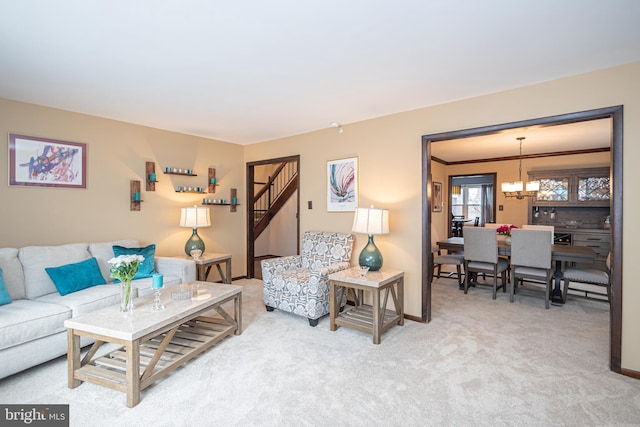 carpeted living room featuring a chandelier, crown molding, and baseboards