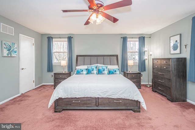 carpeted bedroom with ceiling fan, visible vents, and baseboards