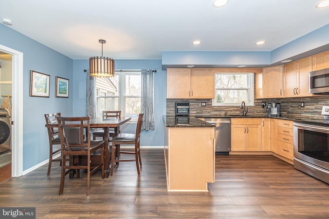 kitchen with stainless steel appliances, light brown cabinetry, backsplash, and dark wood finished floors