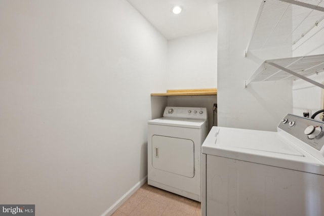 washroom with laundry area, baseboards, and separate washer and dryer