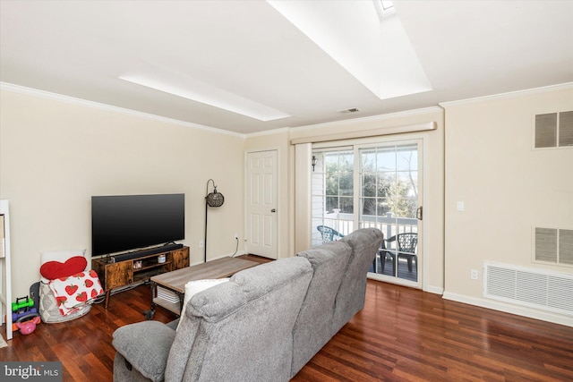 living room featuring dark hardwood / wood-style flooring, a skylight, and ornamental molding