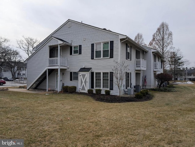 back of property featuring a yard and central AC unit