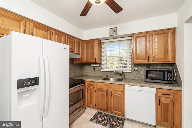 kitchen featuring sink, light tile patterned floors, ceiling fan, appliances with stainless steel finishes, and tasteful backsplash