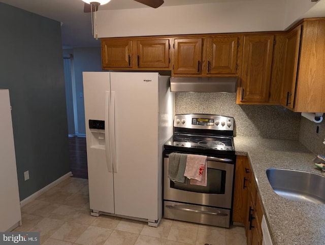 kitchen featuring range hood, tasteful backsplash, sink, stainless steel range with electric cooktop, and white fridge with ice dispenser