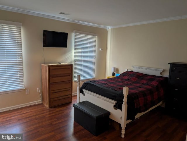 bedroom with ornamental molding and dark hardwood / wood-style flooring