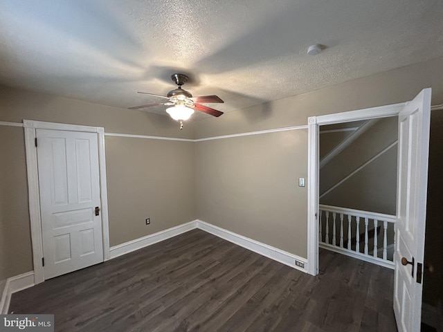 interior space with ceiling fan, a textured ceiling, and dark hardwood / wood-style flooring