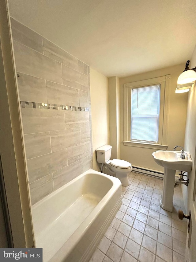 bathroom featuring a washtub, a baseboard radiator, and toilet