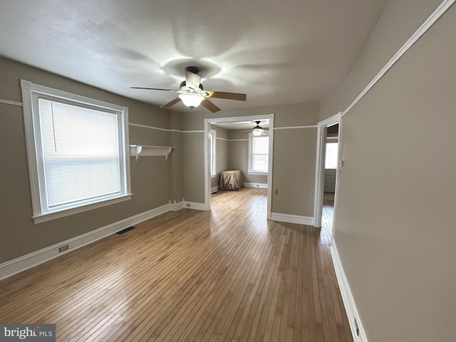 unfurnished room featuring ceiling fan and hardwood / wood-style floors