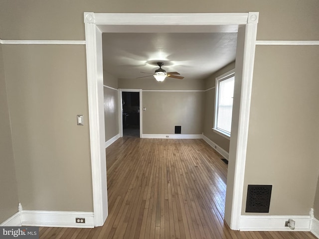 spare room featuring wood-type flooring and ceiling fan