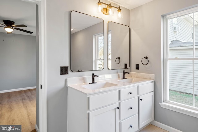 bathroom featuring vanity, hardwood / wood-style flooring, and ceiling fan