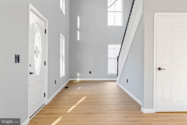 entryway featuring a high ceiling and light wood-type flooring