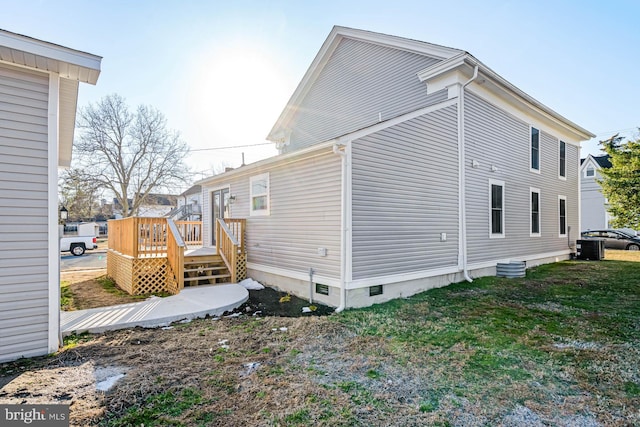 view of home's exterior with a wooden deck and a yard