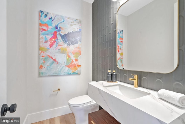 bathroom with vanity, hardwood / wood-style floors, and toilet