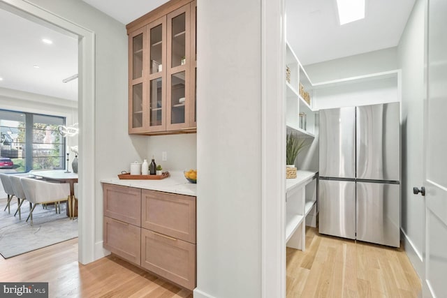 interior space featuring light stone counters and light wood-type flooring