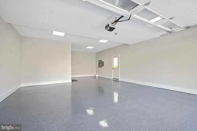 garage with a garage door opener and electric panel