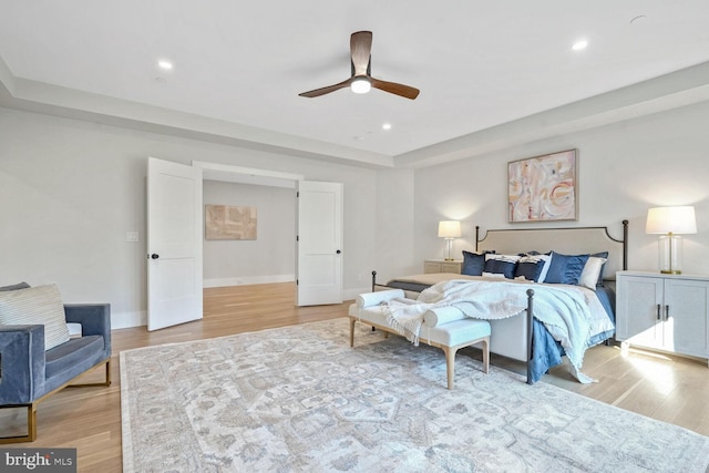 bedroom with ceiling fan and light hardwood / wood-style floors