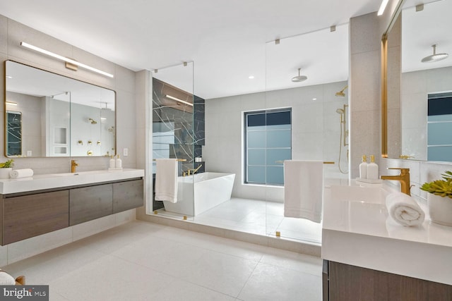 bathroom with tile patterned flooring, plus walk in shower, tile walls, and vanity