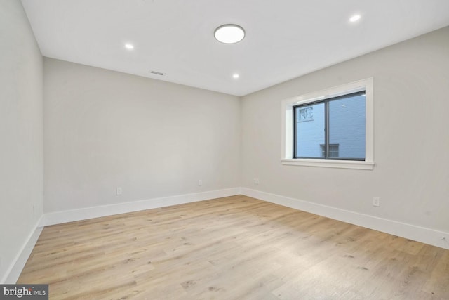 spare room featuring light hardwood / wood-style flooring