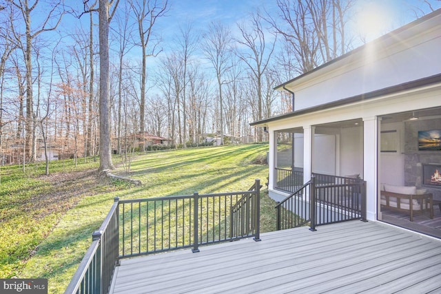 wooden terrace featuring a yard and a sunroom