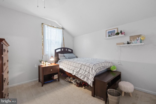 carpeted bedroom with lofted ceiling