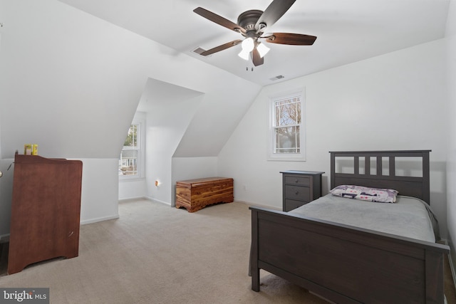 carpeted bedroom with vaulted ceiling and ceiling fan