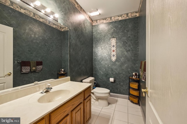 bathroom with tile patterned flooring, vanity, and toilet