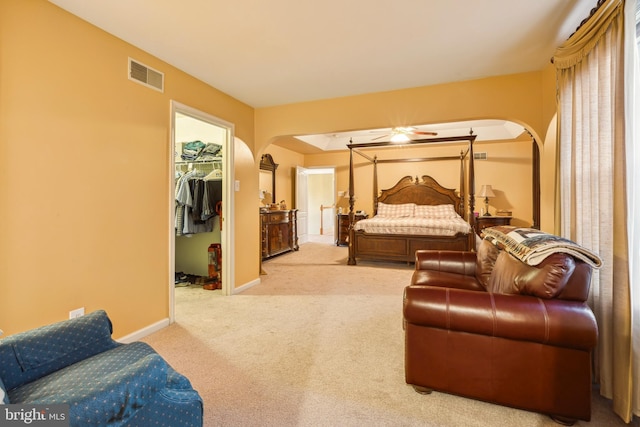 carpeted bedroom with a spacious closet