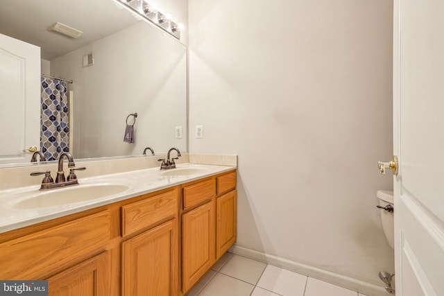 bathroom featuring tile patterned flooring, vanity, and toilet