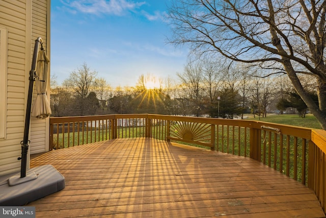 deck at dusk with a lawn