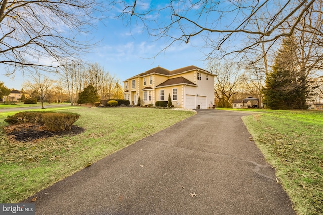 view of front facade with a garage and a front lawn