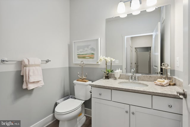 bathroom featuring vanity and toilet