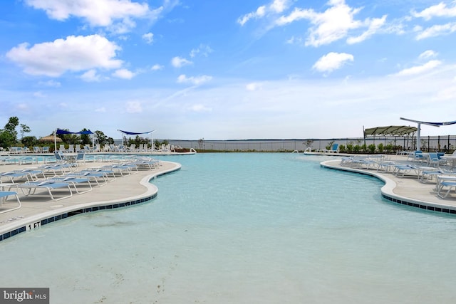 view of swimming pool with a water view